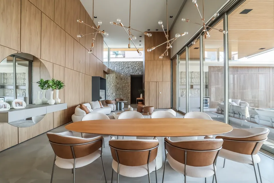 Sala de jantar com pé-direito alto e painéis de madeira